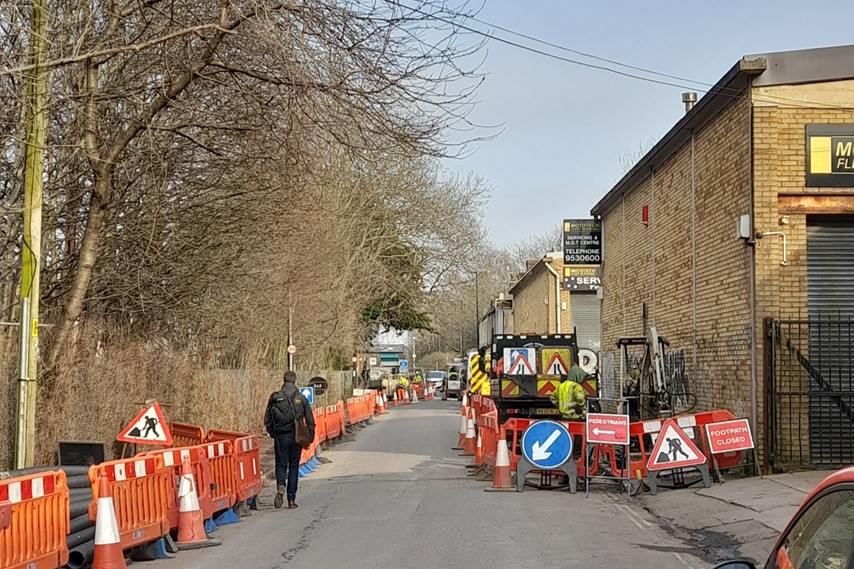 A person walks past roadworks on Whitehouse Lane in Bedminster