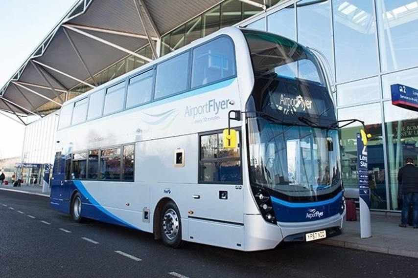 The blue and grey airport flyer bus parked outside Bristol airport